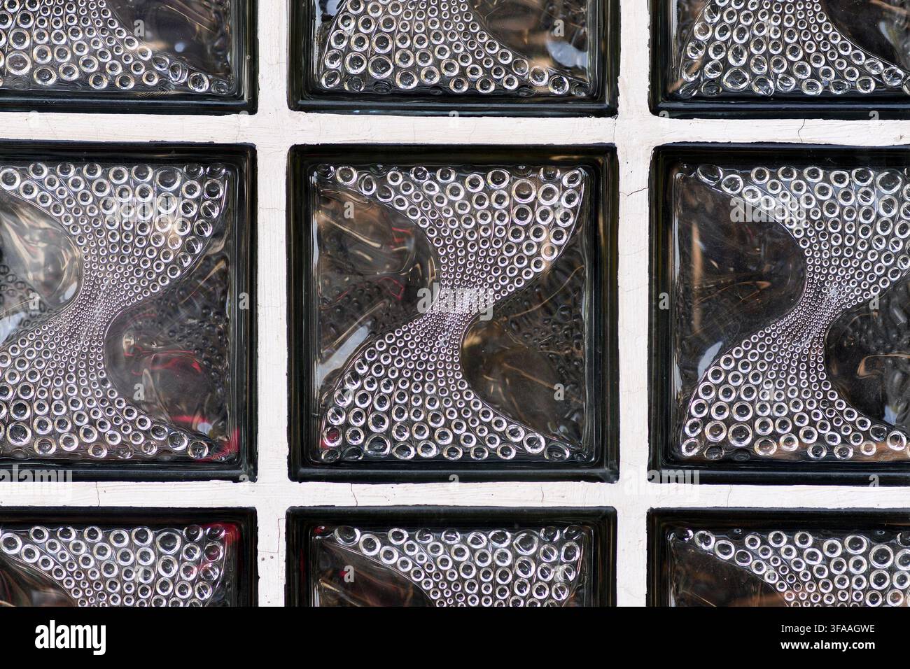 Textured translucent glass block wall with curved circular pattern Stock Photo