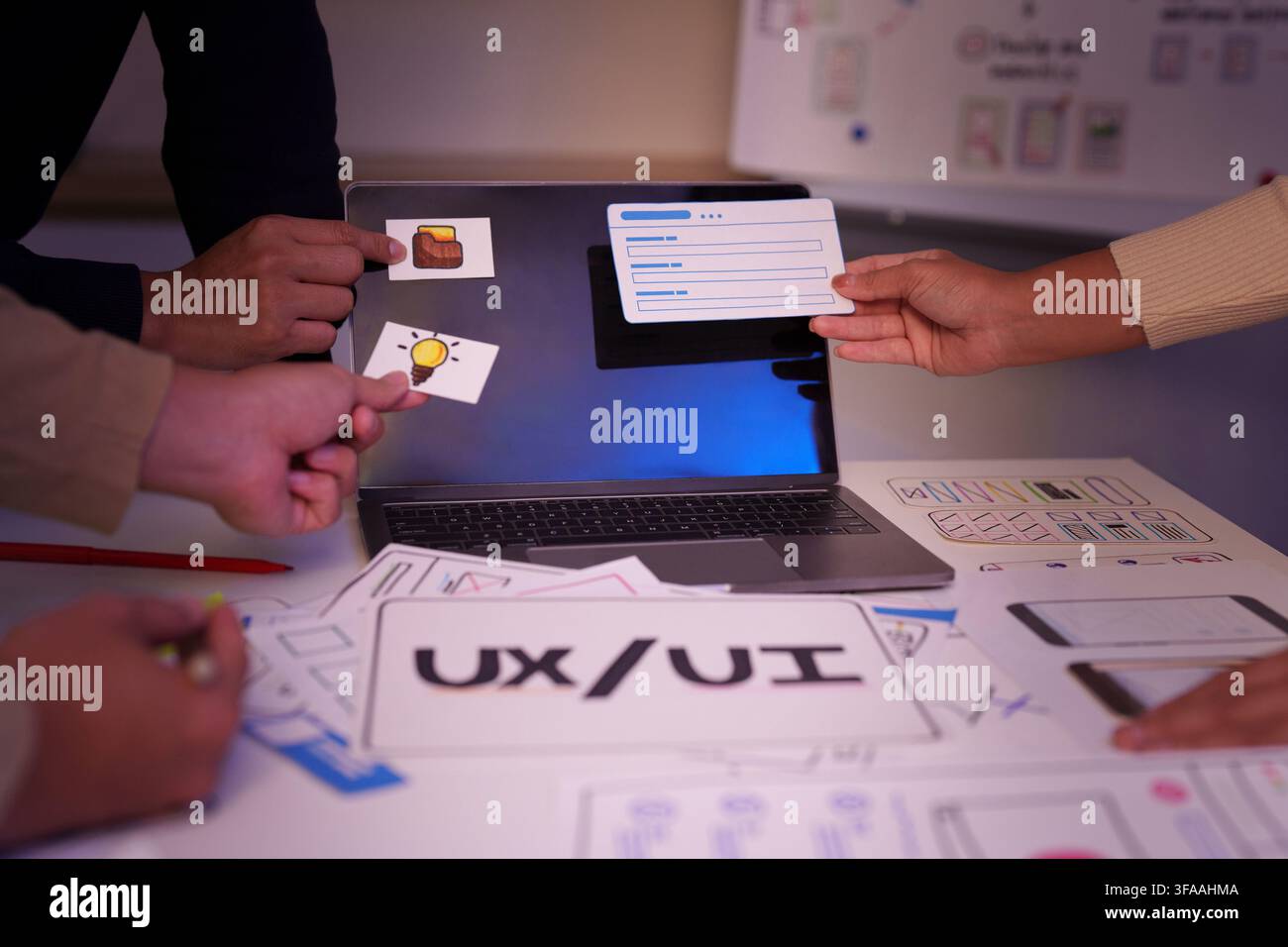 UX UI designer team placing layout elements on laptop for web application prototype Stock Photo