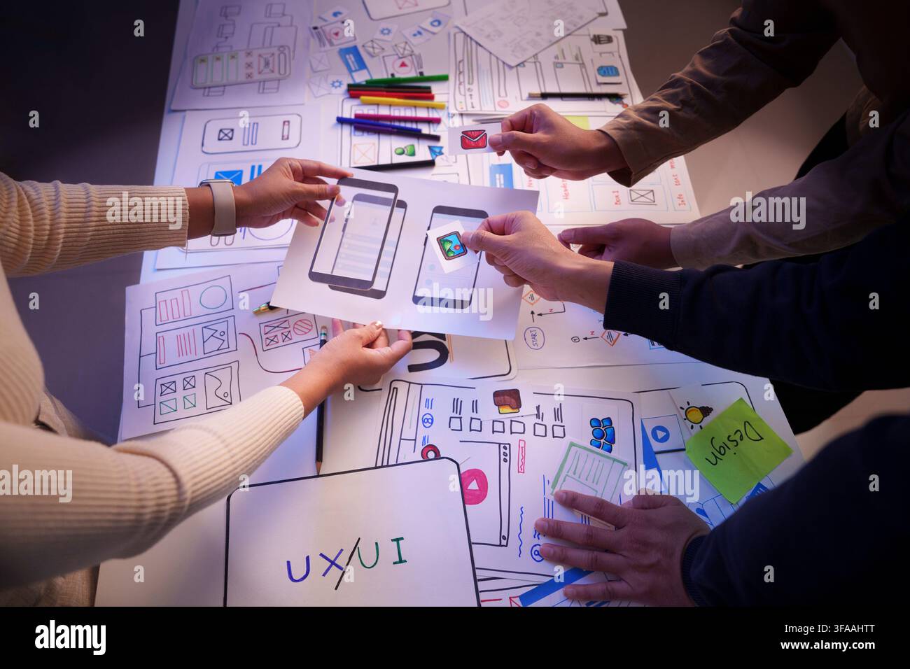 UX UI design team planning mobile application interface wireframes overhead view Stock Photo