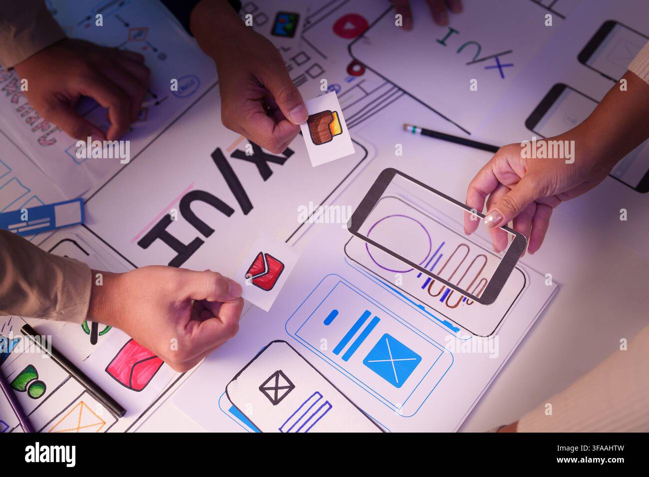 UX UI designer team collaborating on mobile app interface wireframe layout prototype Stock Photo