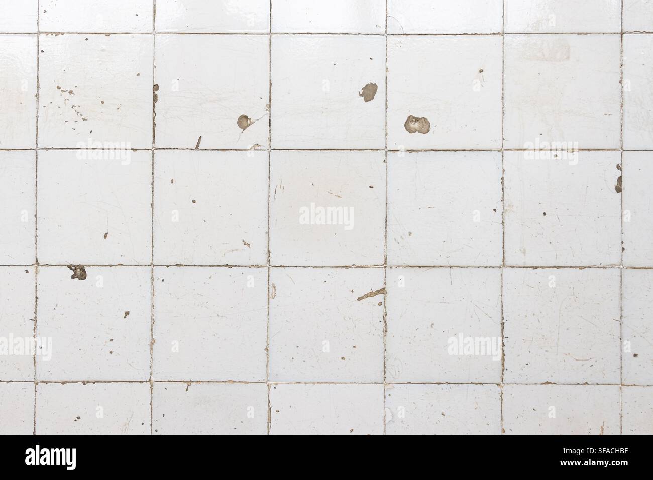 weathered grunge white ceramic tile wall abstract background texture Stock Photo