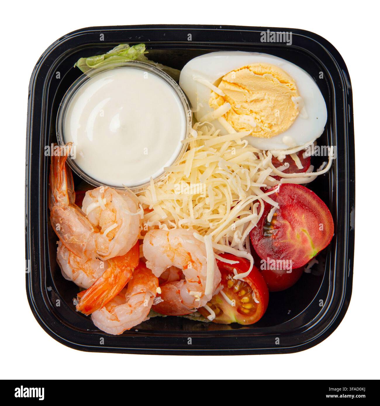 Caesar salad with shrimp and sauce box isolated Stock Photo