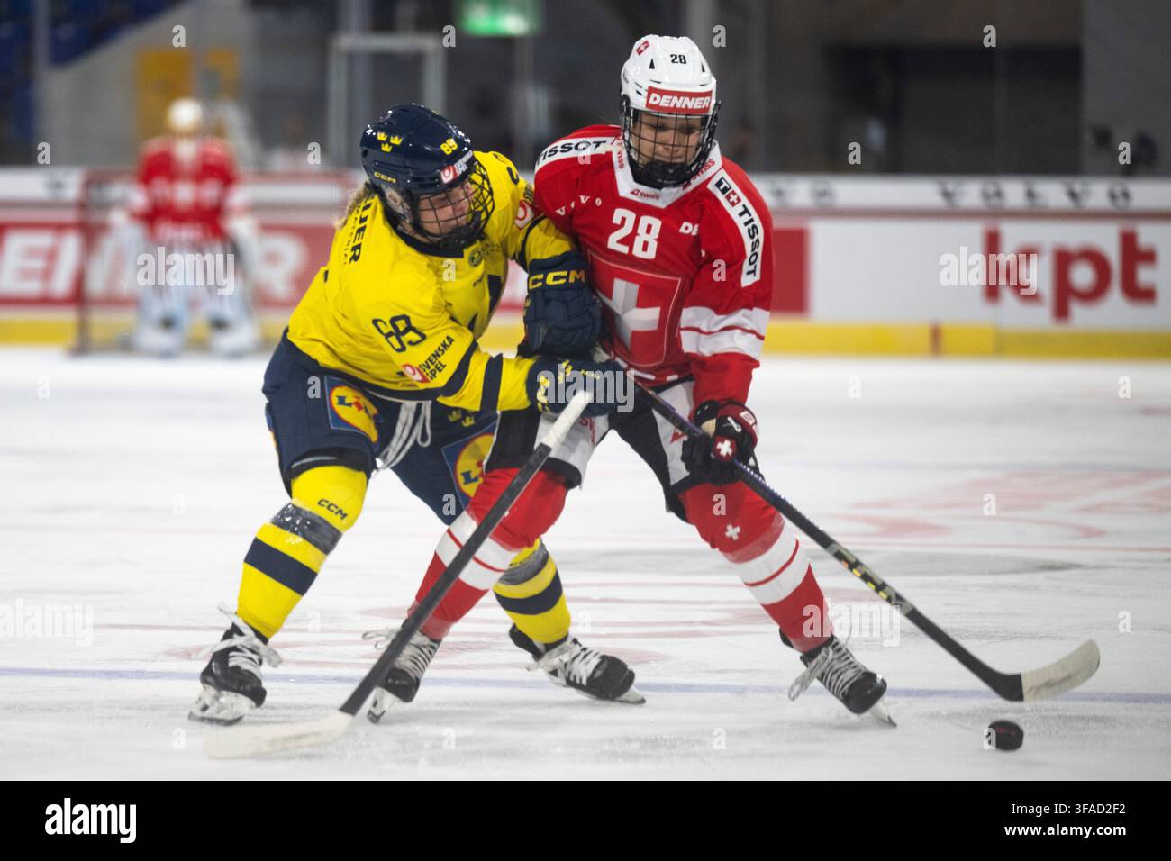 sweden-s-nicole-hall-left-battles-for-the-puck-with-switzerland-s