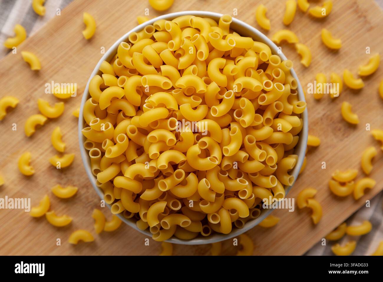Dry Organic Elbow Macaroni Pasta in a Bowl, top view. Stock Photo