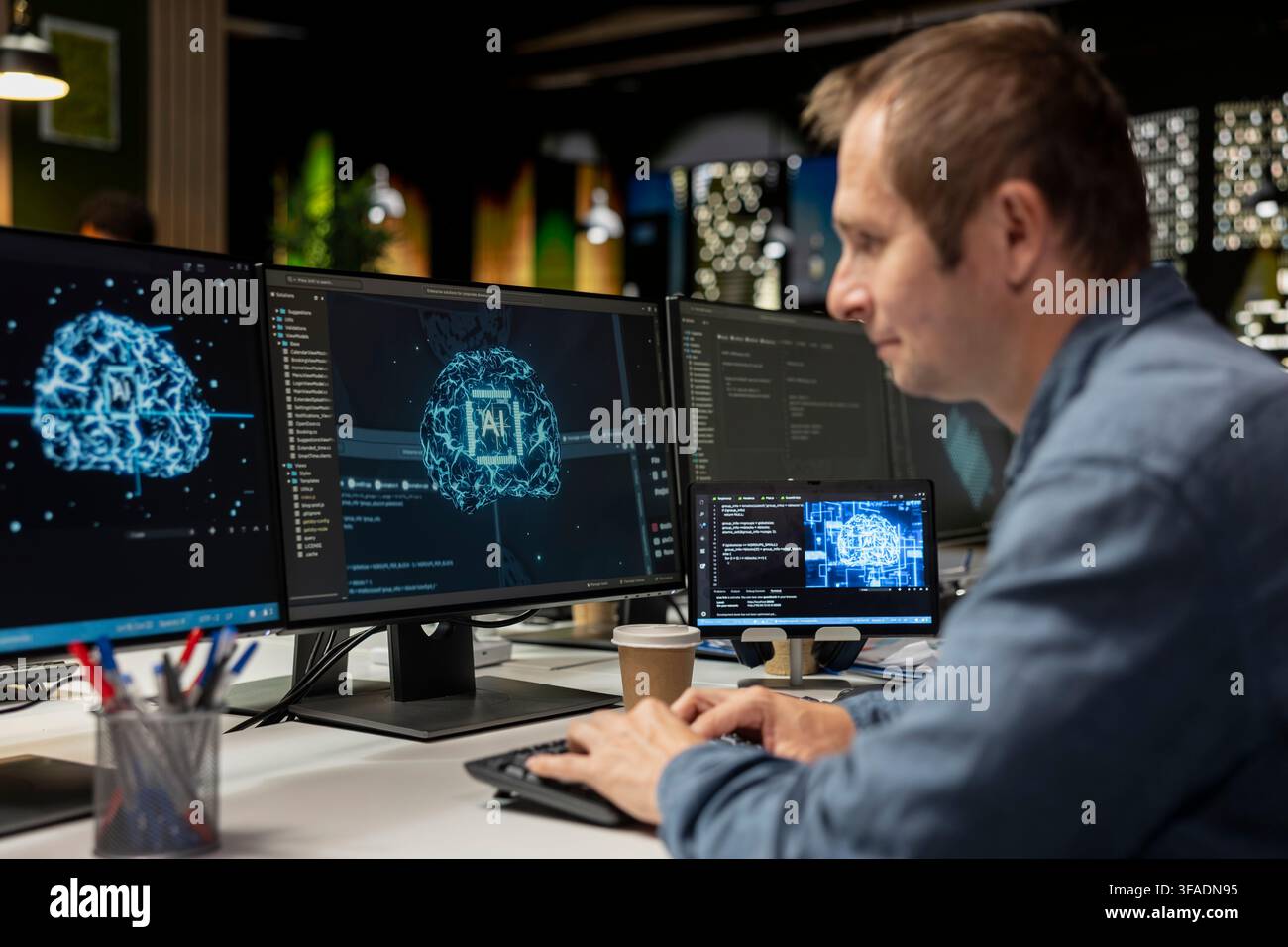 Man utilizing artificial intelligence on computer to optimize performance and forecast issues. IT professional in tech company office training deep learning models to perform automatic updates Stock Photo