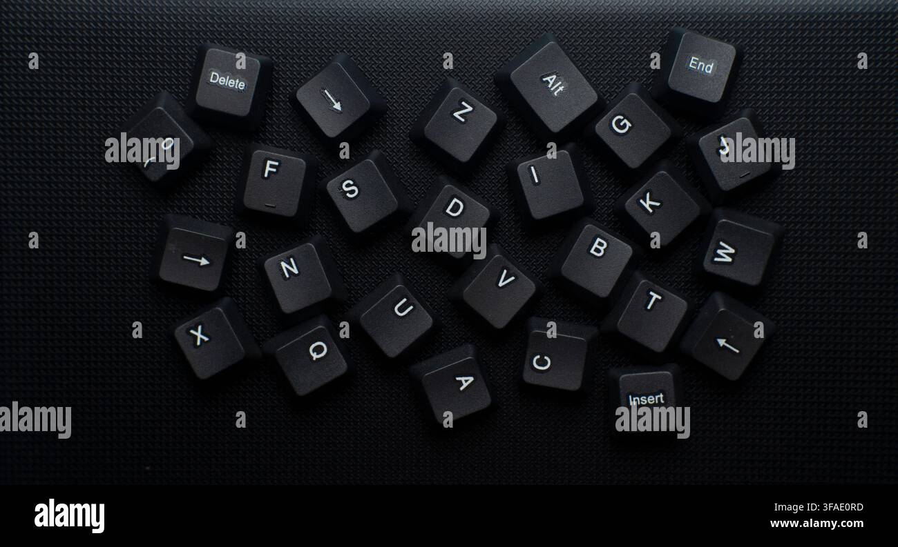Scattered Computer Keyboard Keys On Dark Background ideal for technology, computer hardware, digital chaos, data disorder, coding Stock Photo