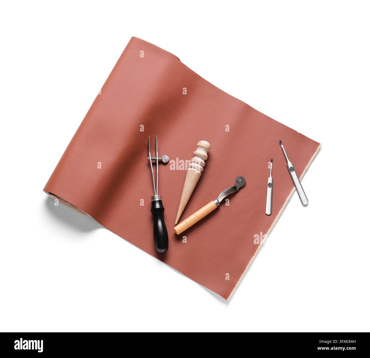 Leather crafting and handmade goods concept, tools for working with leather on a brown material background Stock Photo