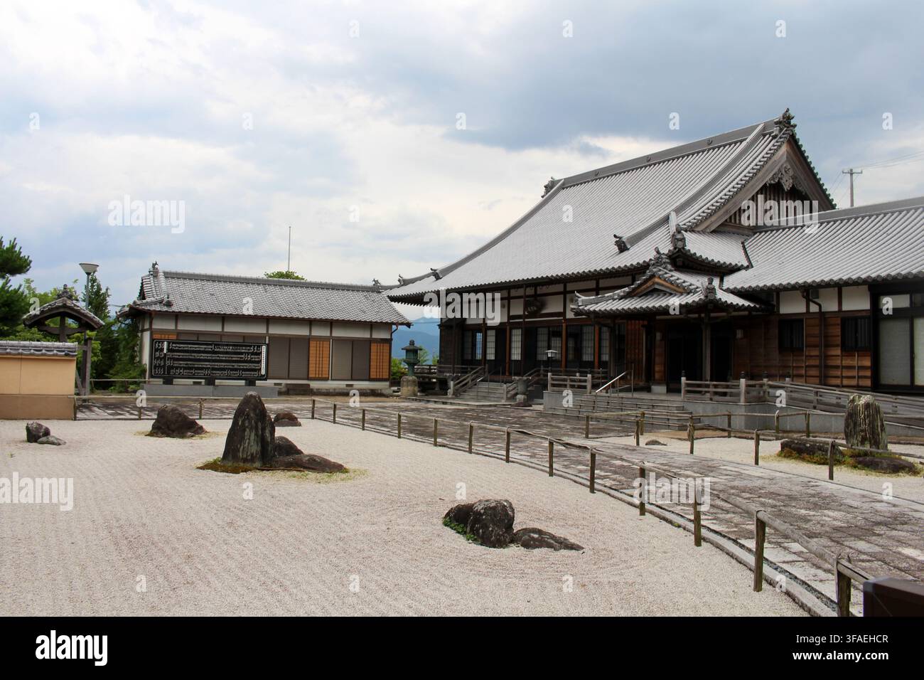Traditional wooden temple halls with a meticulously raked zen gravel ...