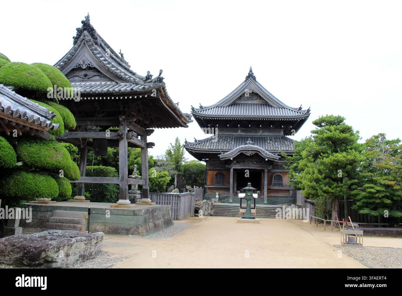 Wooden temple halls alongside a historic wooden belfry tower in the ...
