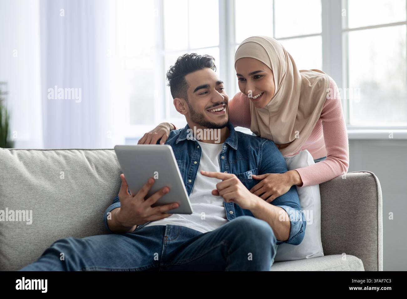 Young muslim couple using mobile app on digital tablet Stock Photo