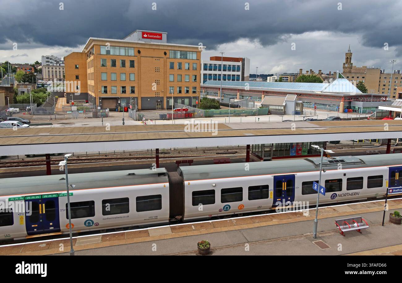 Bradford Interchange railway platforms with Northern train and Santander offices beyond, showing transport and city-centre redevelopment. Stock Photo
