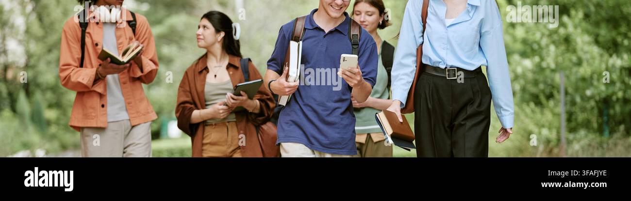 Header of Diverse Students with Books Using Smartphone While Walking on Campus Stock Photo