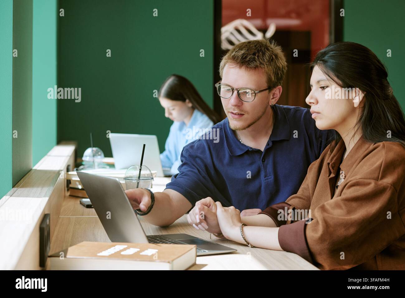 Diverse Students Studying Together with Laptop on Campus Stock Photo