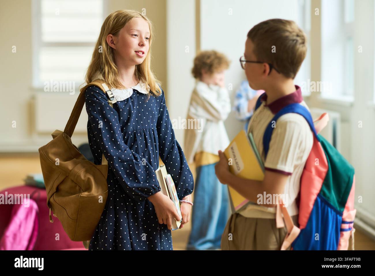 Schoolchildren Talking in Hallway during Break in Elementary School Stock Photo
