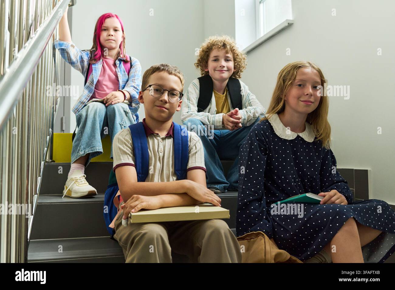 Portrait of Diverse Group of School Children Sitting on Stairs Stock Photo
