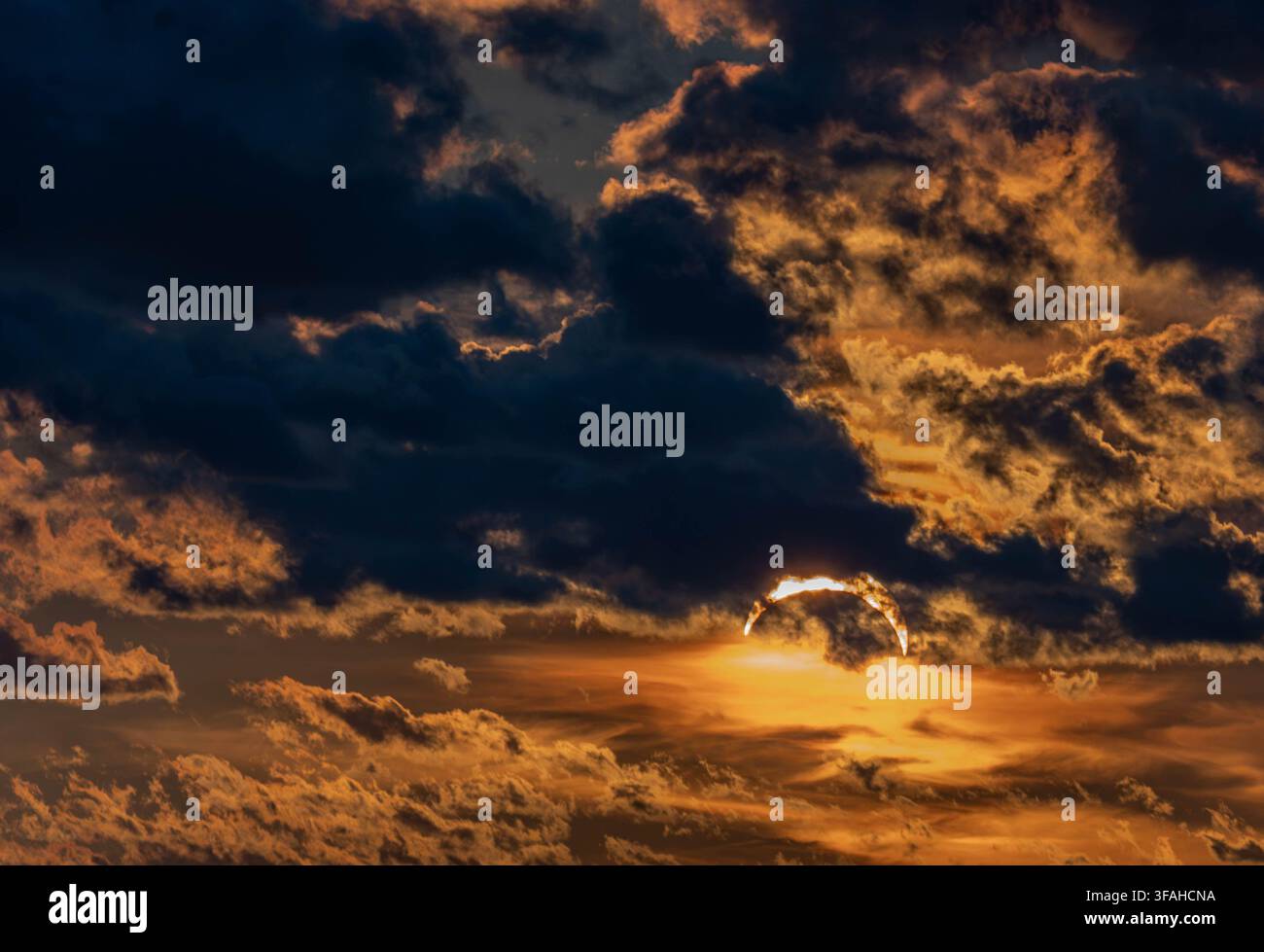 Partial solar eclipse seen through dramatic clouds over Saulkrasti, Latvia, on 12 August 2026 Stock Photo