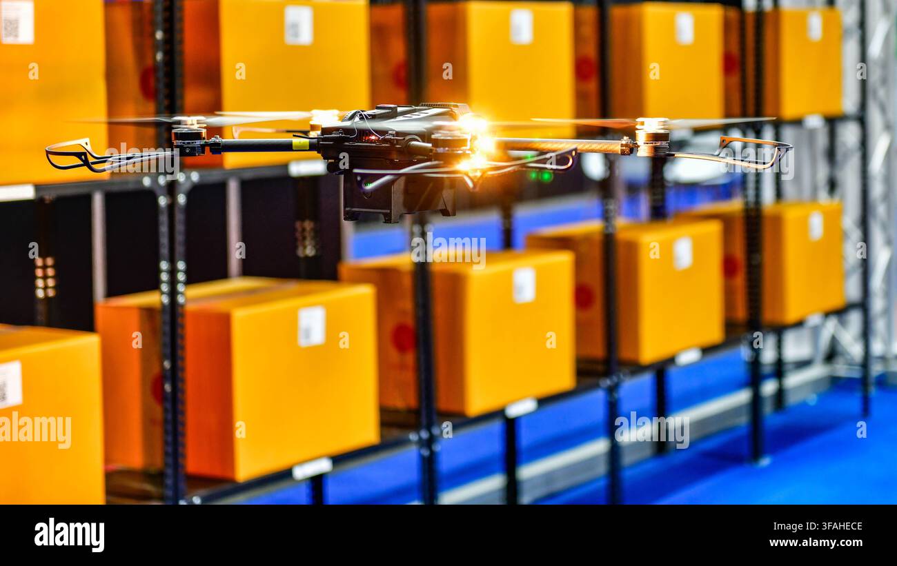 Autonomous drone flying inside modern warehouse for inventory scanning and smart logistics technology Stock Photo