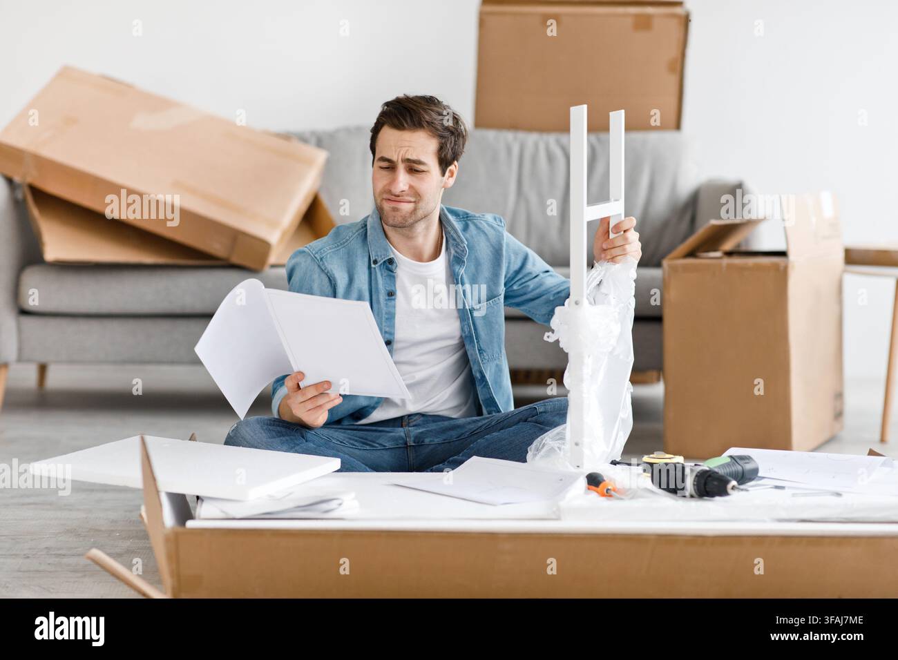 Difficulties and problems in assembling new furniture at home without master Stock Photo