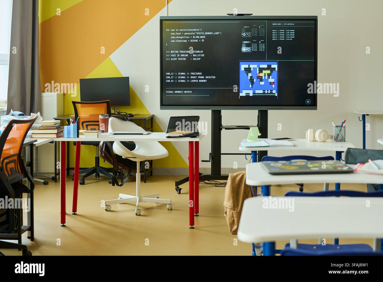 Empty Modern Classroom with Coding Software on Interactive Screen Stock Photo