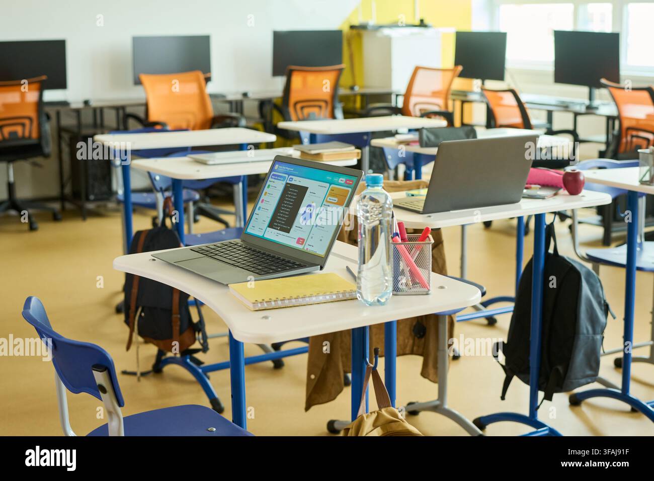 Laptops on Desks in Empty Computer Science Classroom Stock Photo