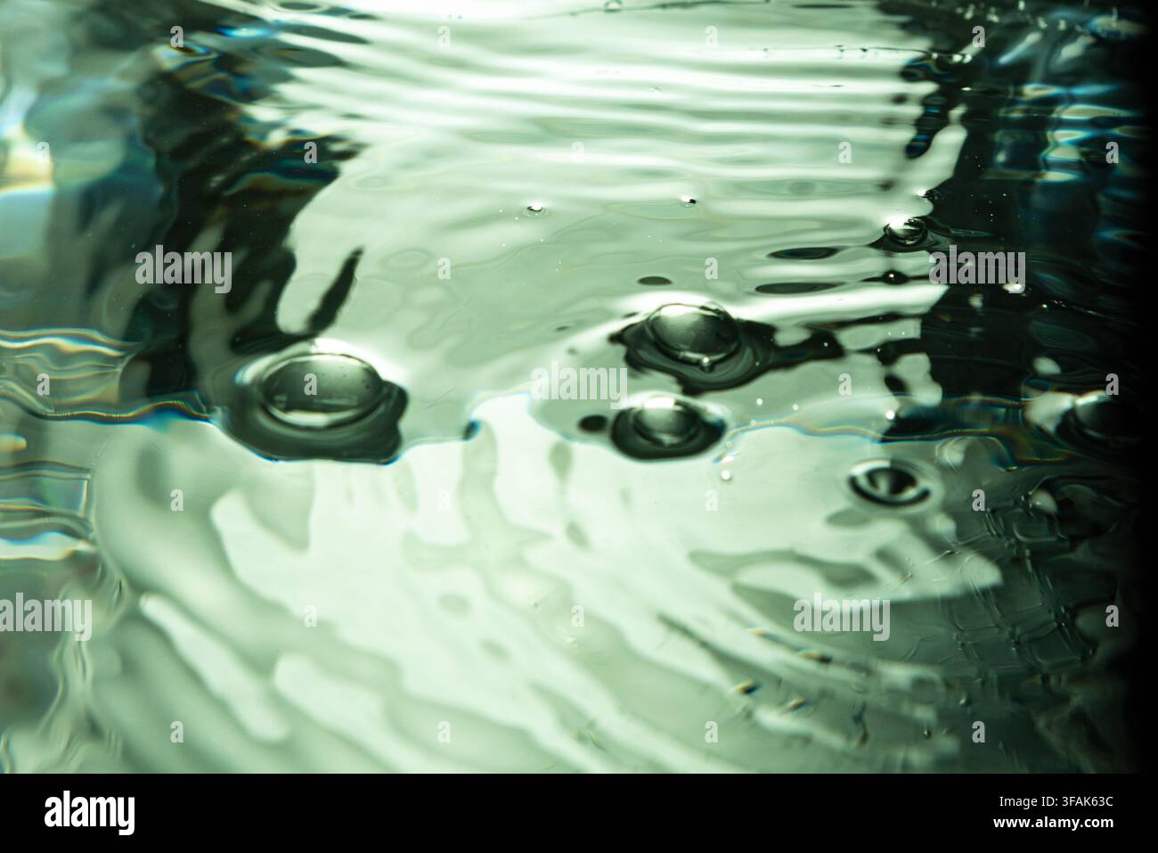 223.Ripples and Bubbles on Reflective Water Surface Stock Photo