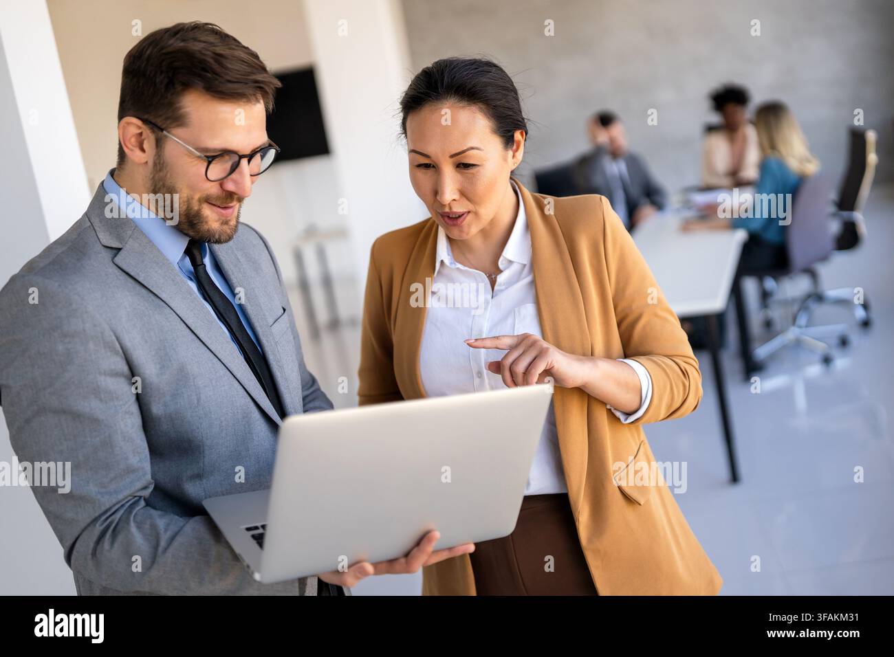 Mixed team of software engineers brainstorming ideas. Diverse app developers collaborating as group Stock Photo