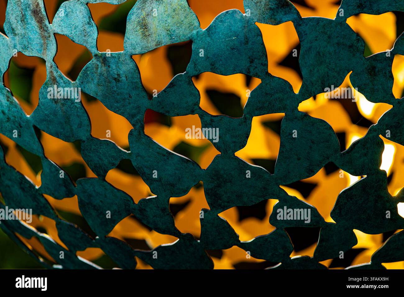 A close-up detail of a dark verdigris-patinated bronze outdoor sphere sculpture, Stock Photo