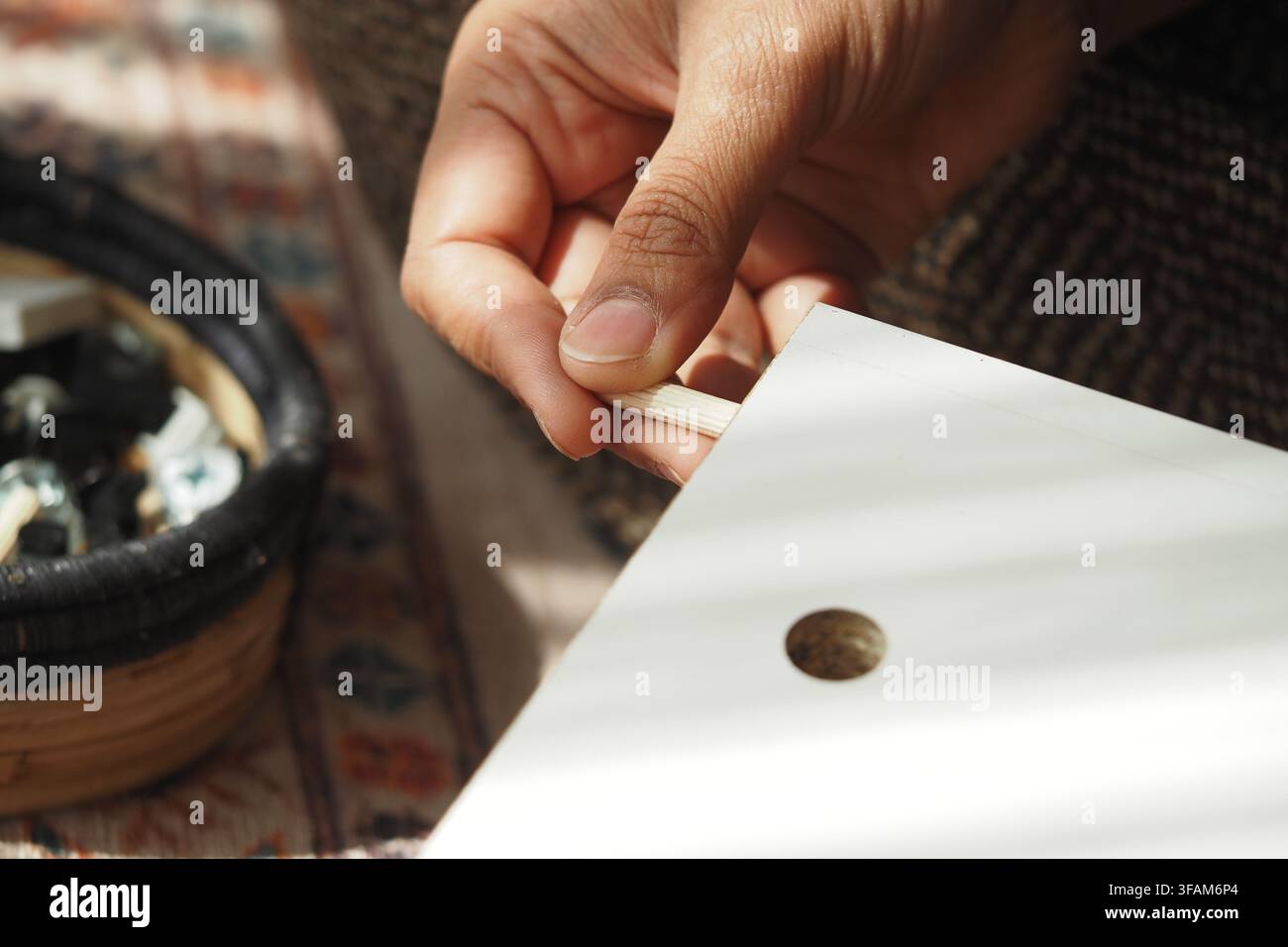 Person working on wood project at home Stock Photo