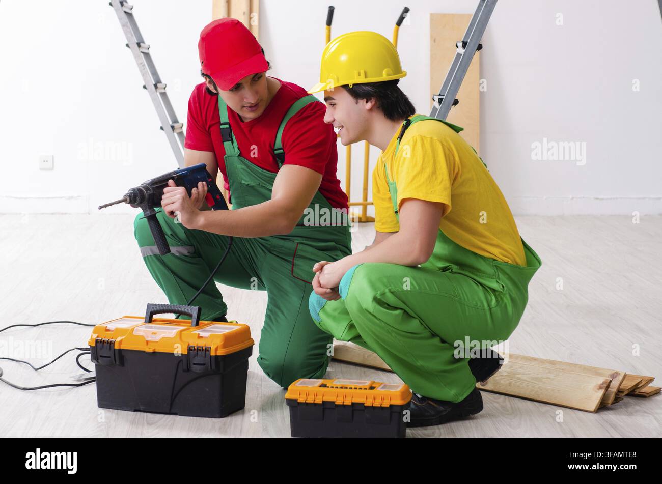 Two workers, contractors working indoors Stock Photo