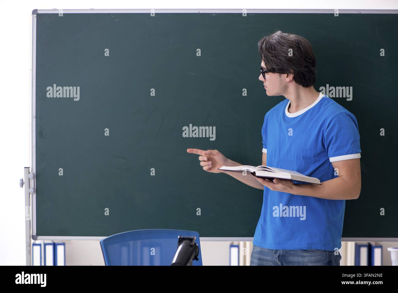 Young male student in classroom Stock Photo