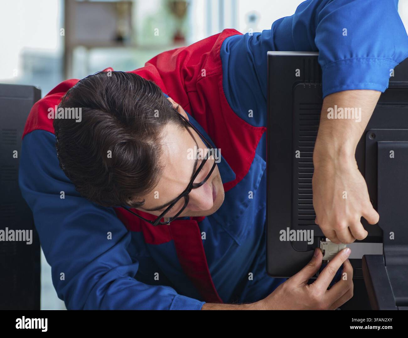 Computer mechanic works on repairing computers in an IT workshop Stock Photo