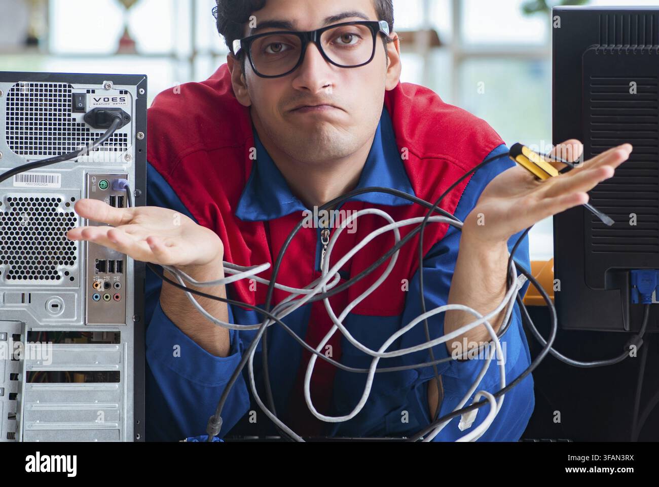 Computer mechanic works on repairing computers in an IT workshop Stock Photo