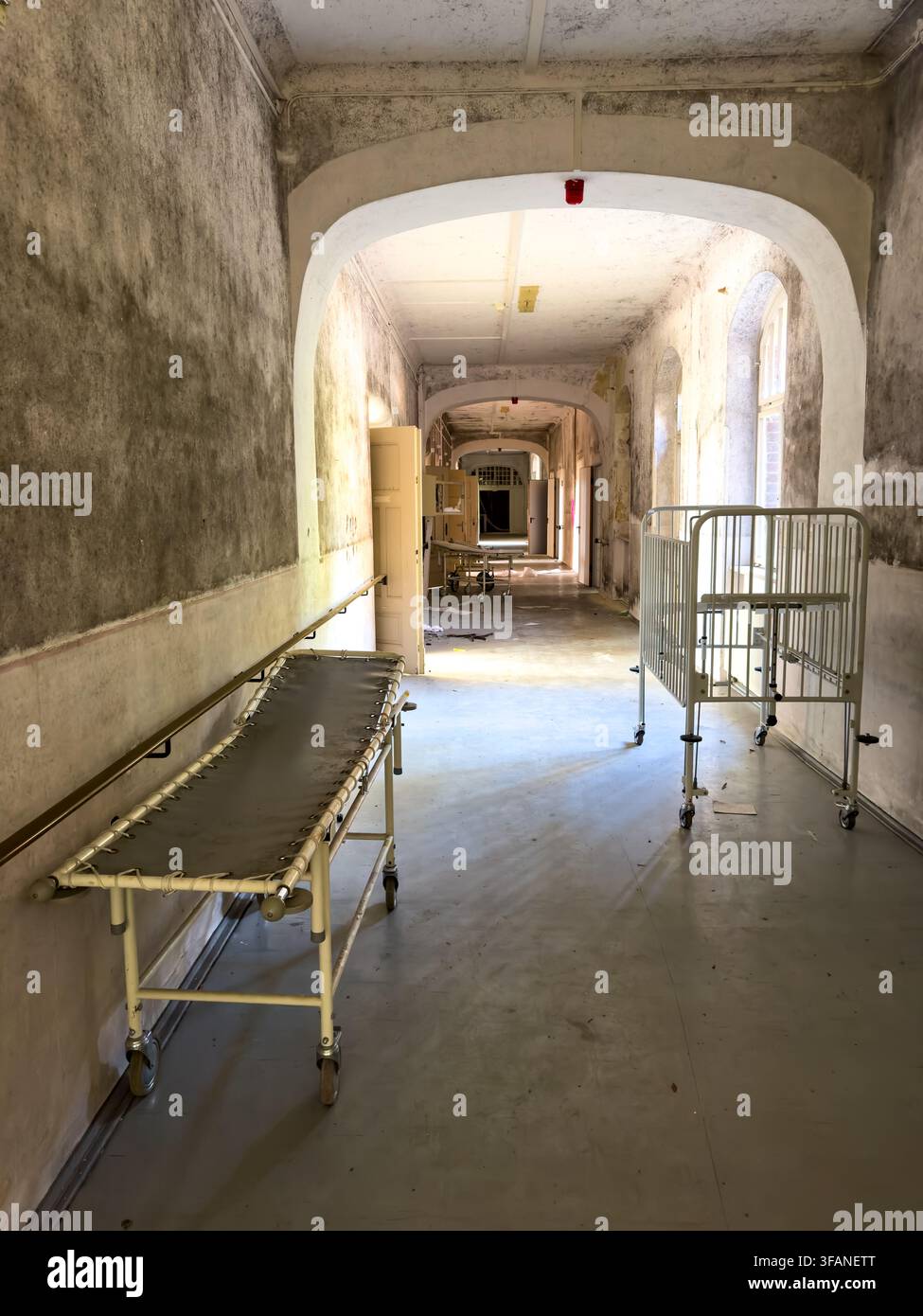 old abandoned Hospital corridor with sick bed in a lost place sanatoriumvertical Stock Photo