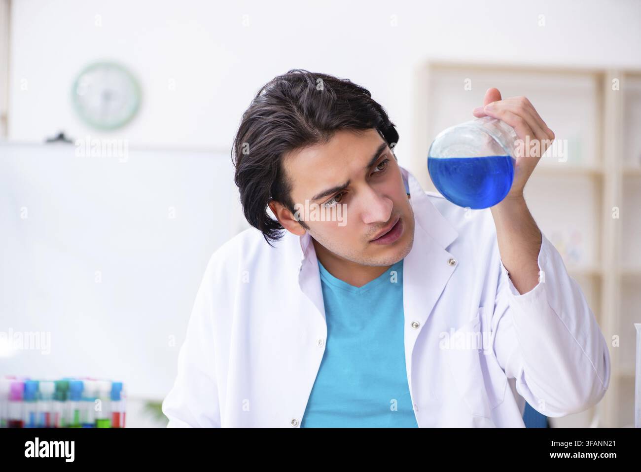 Young male chemist working in laboratory Stock Photo