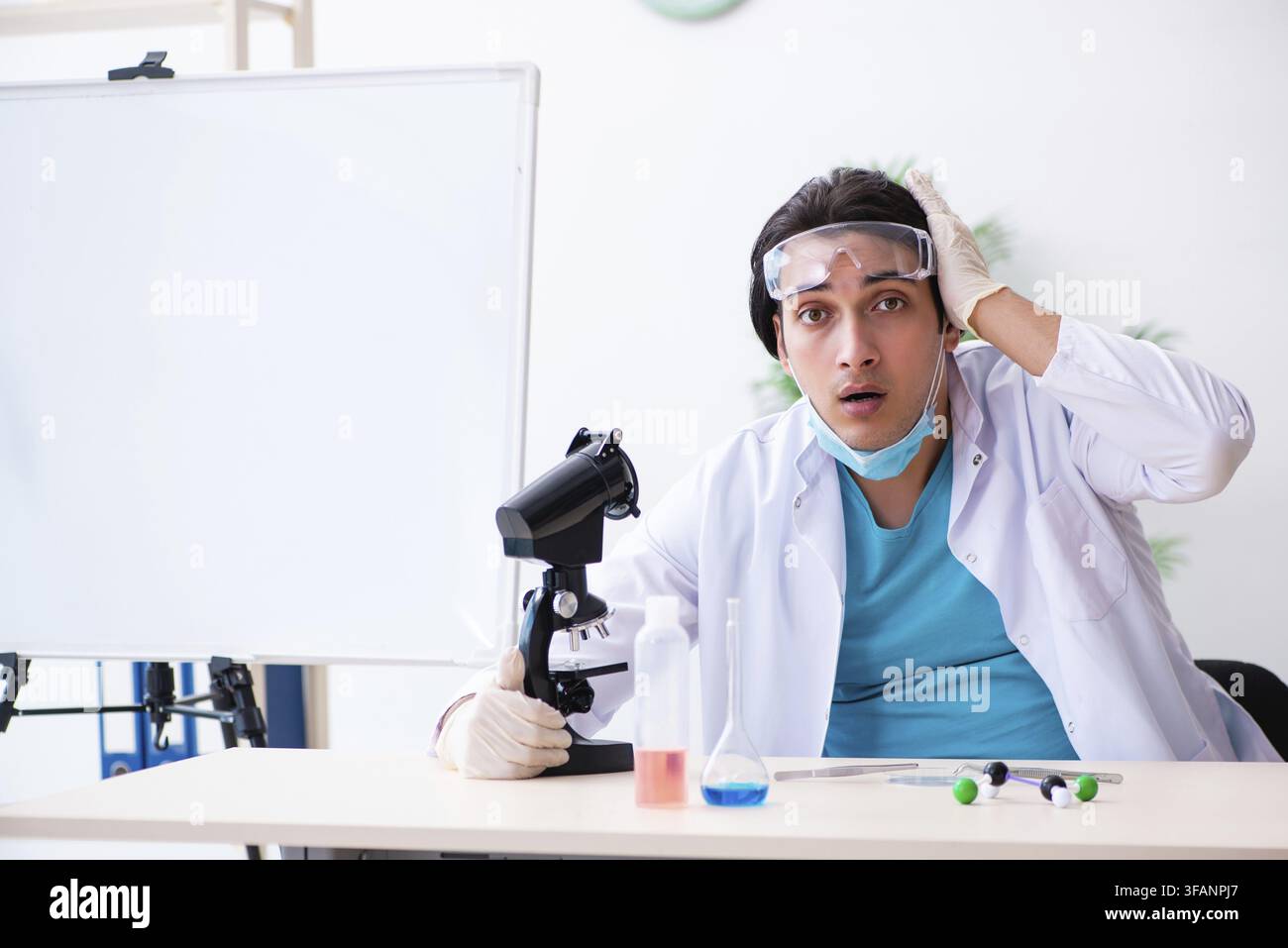 Young male chemist working in laboratory Stock Photo