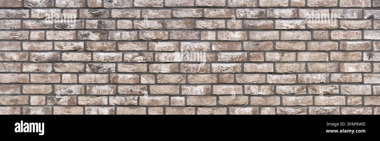 Panorama wall made of rectangular stones with abstract brown white pattern Stock Photo