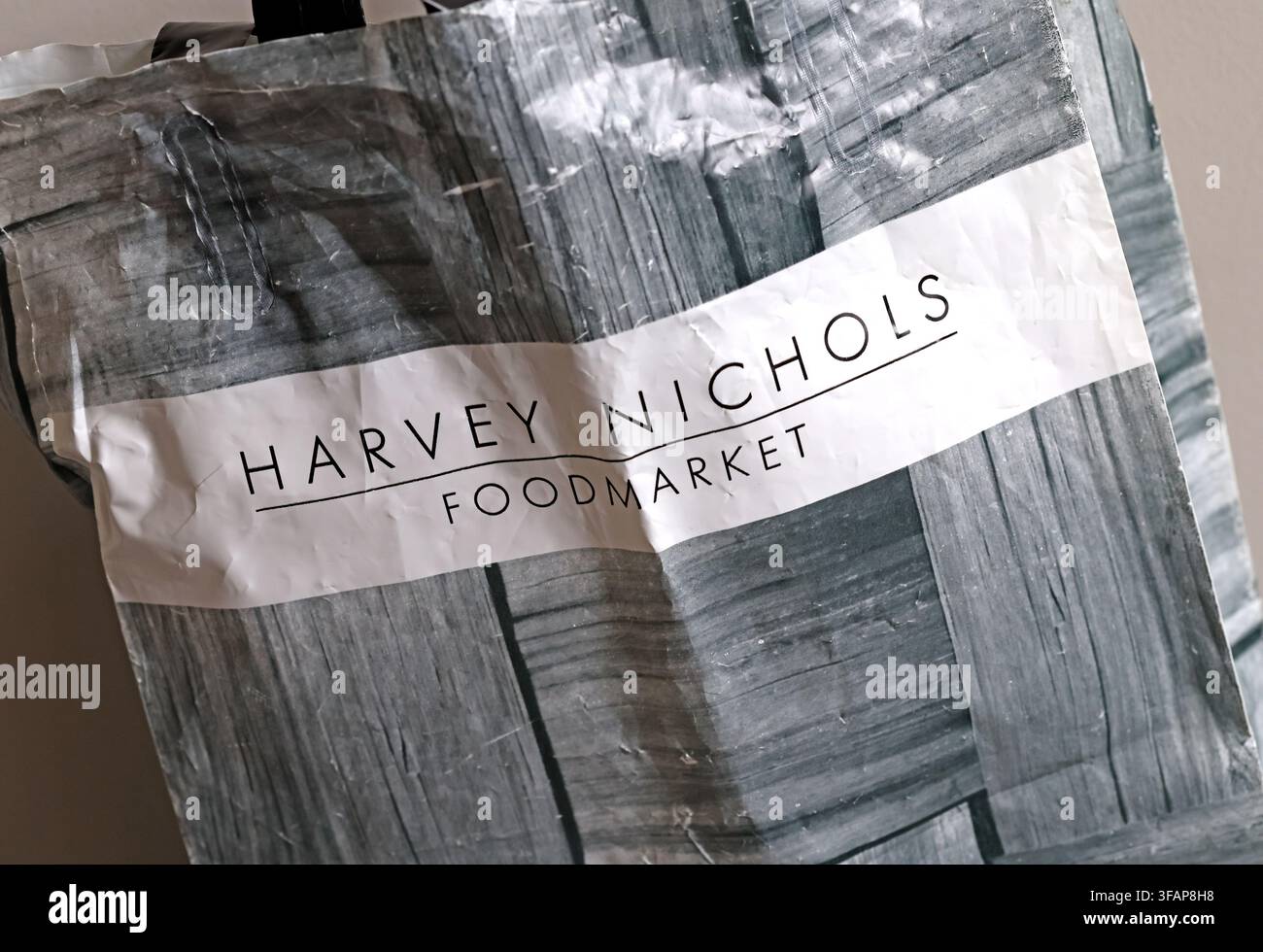 Harvey Nichols foodMarket carrier bag photographed in August 2026 amid restructuring news involving Frasers Group and Mike Ashley. Stock Photo