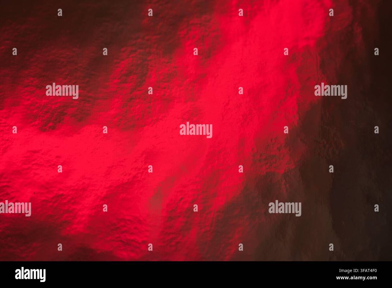A deep red foil texture abstract background with metallic sheen. Stock Photo