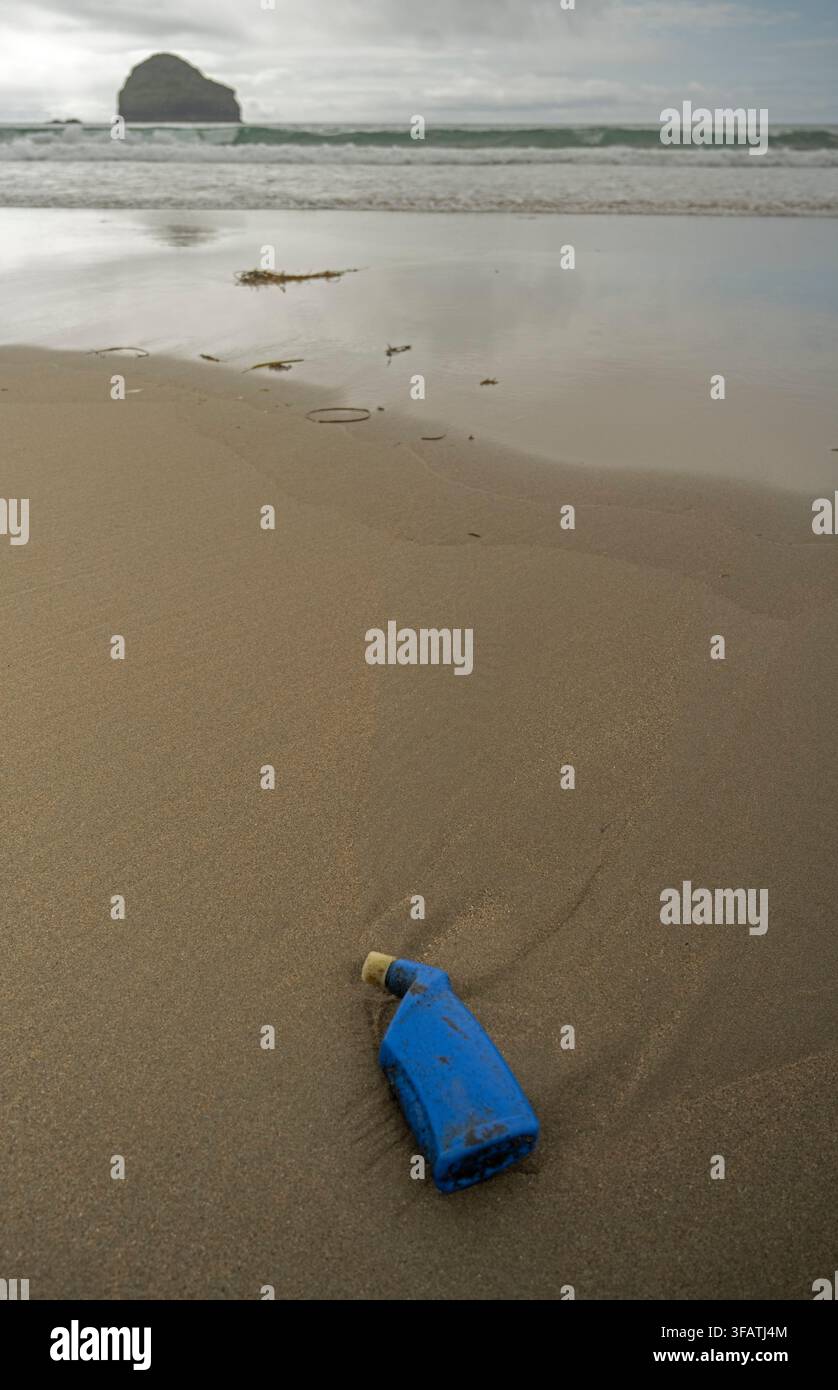 Plastic bottle washed up on remote beach. Cornwall, UK Stock Photo
