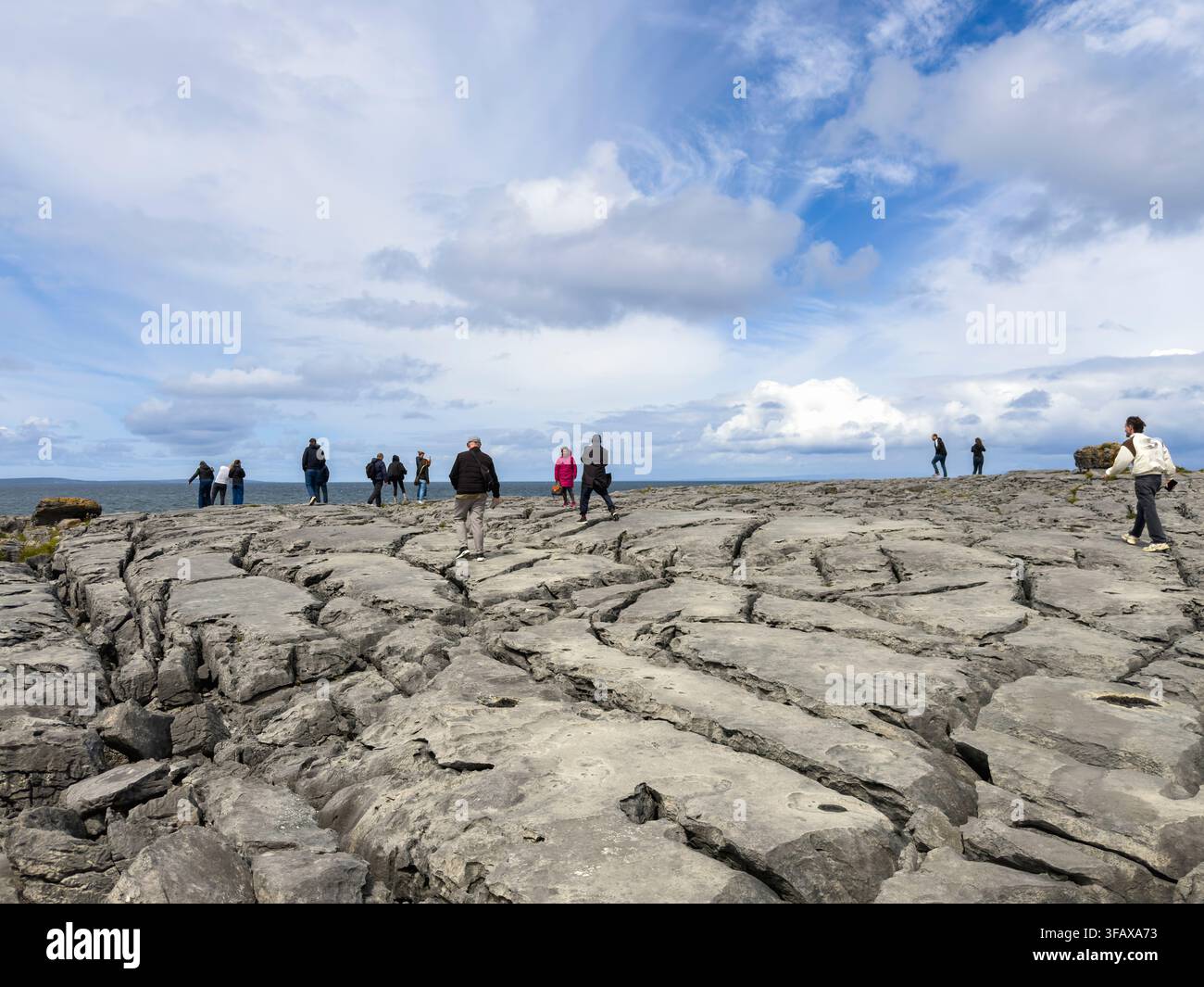 Tourists walking at The Burren, karst/glaciokarst landscape, rock formations at County Clare, west coast of Ireland - Smartphone Captured Stock Image