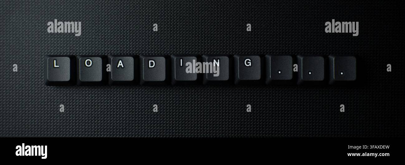 Loading Progress Message With Keyboard Keys On Dark Background Stock Photo