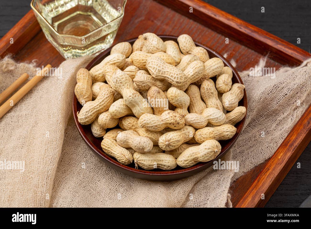 Roasted peanuts in shell served on blue dish Stock Photo