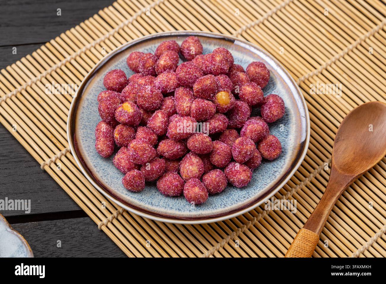 Purple coated crispy peanuts served in small plate Stock Photo