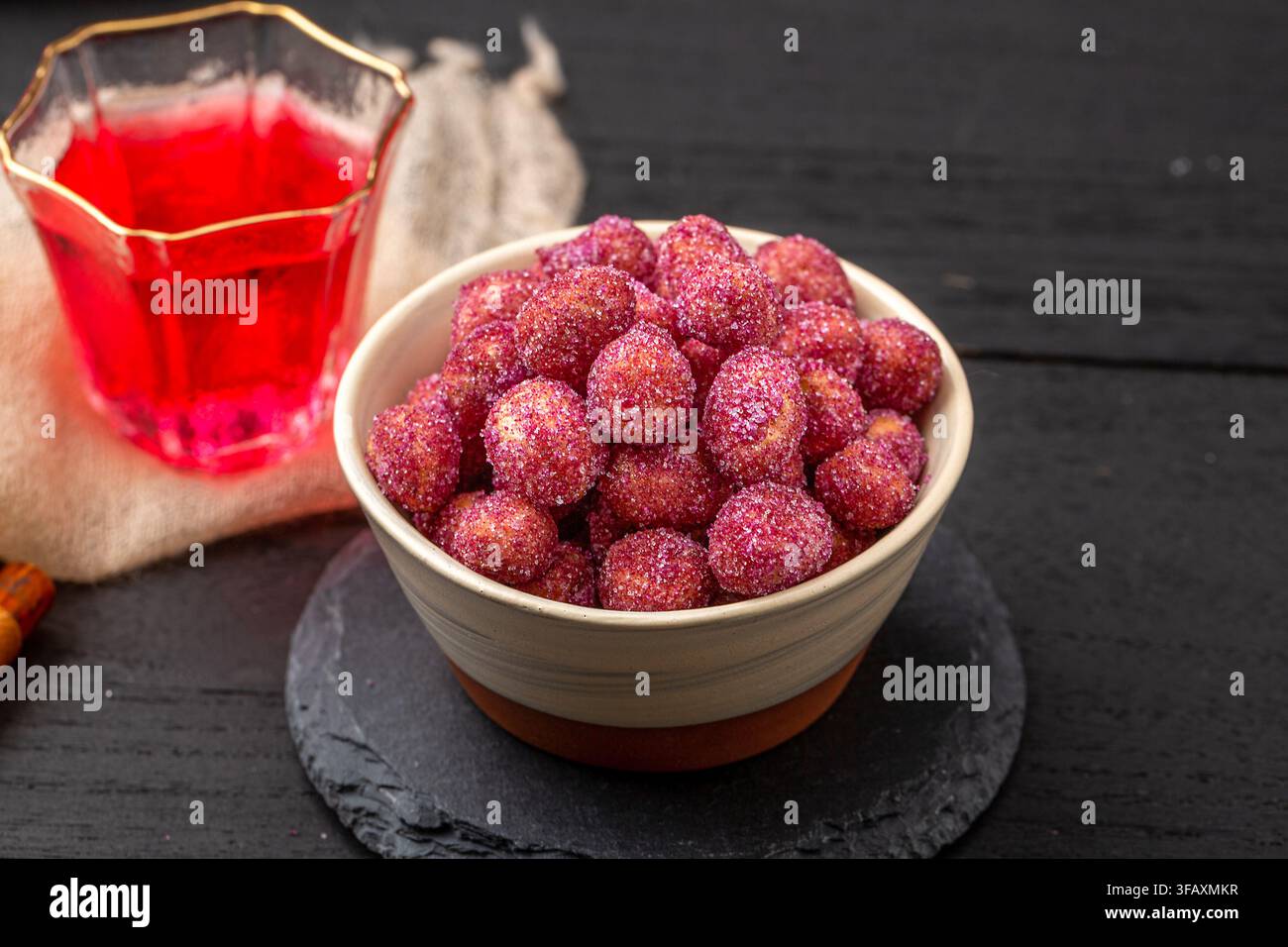 Purple coated crispy peanuts served in small plate Stock Photo