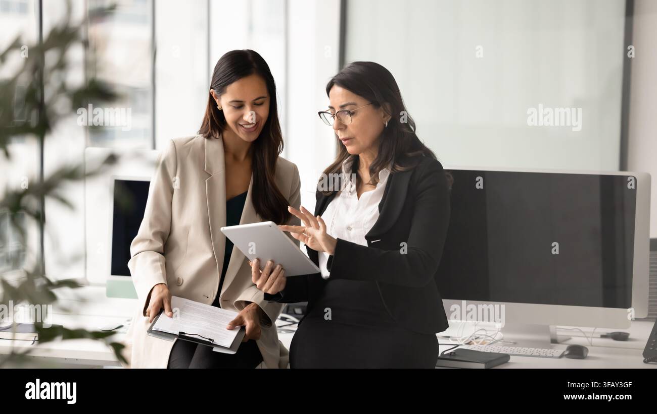 Team members working on project using digital tablet during briefing Stock Photo