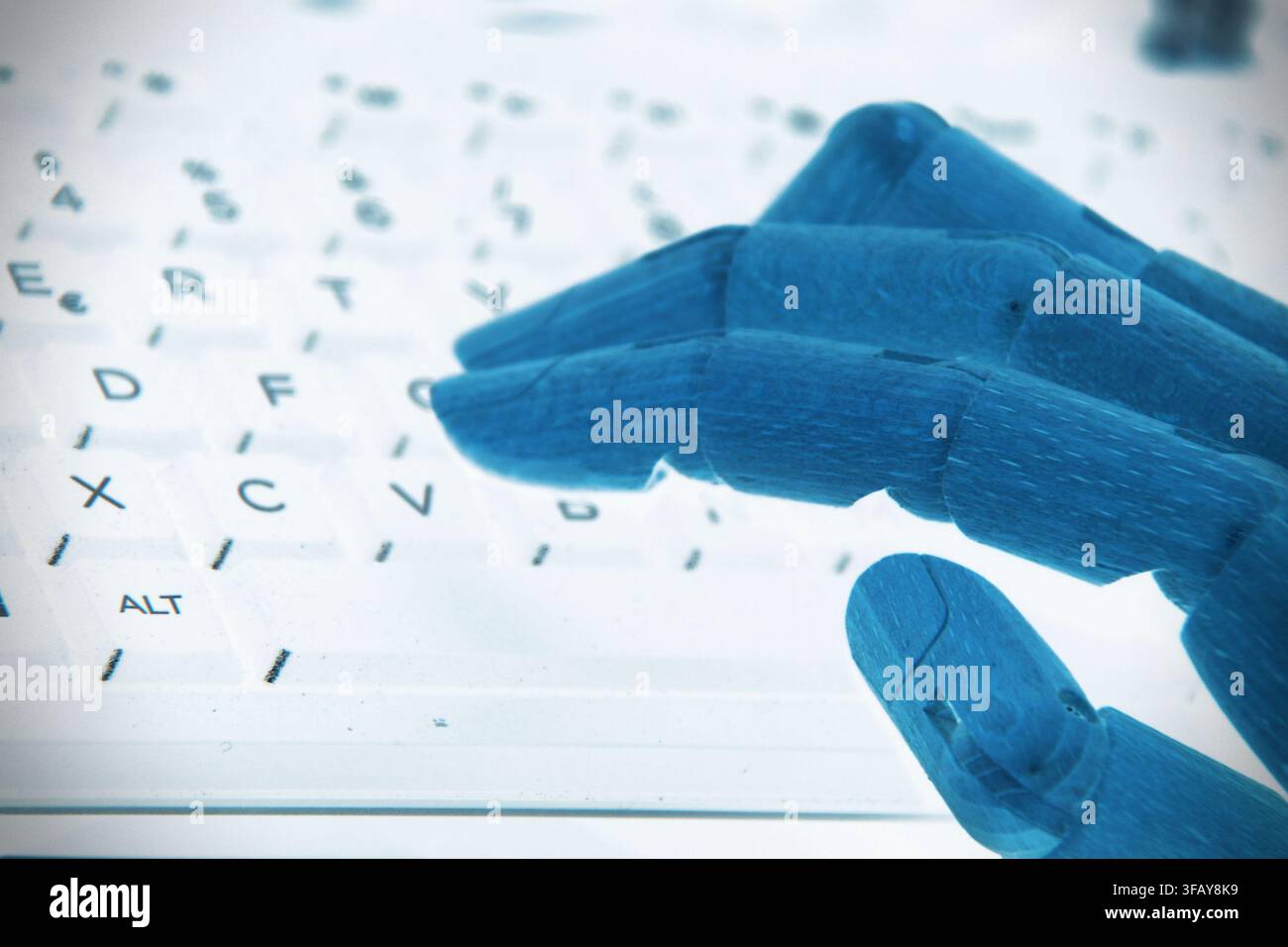 A robotic hand placed on a computer keyboard, symbolizing artificial intelligence, automation, digital interaction, and the connection between humans Stock Photo