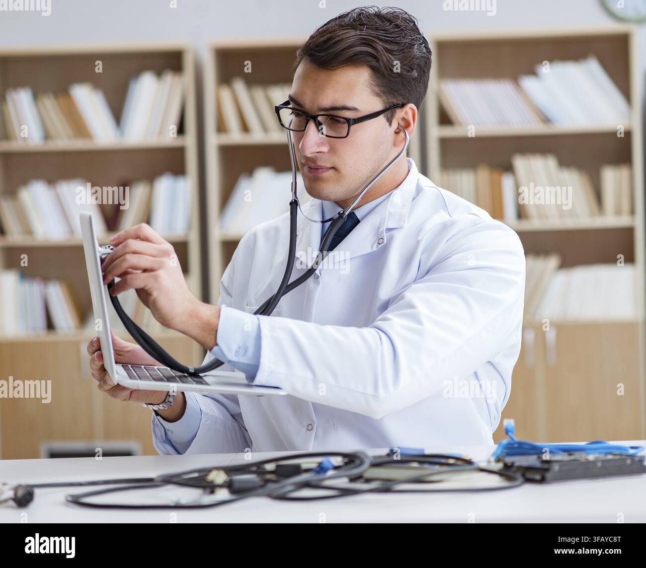The IT technician repairs a broken laptop notebook Stock Photo