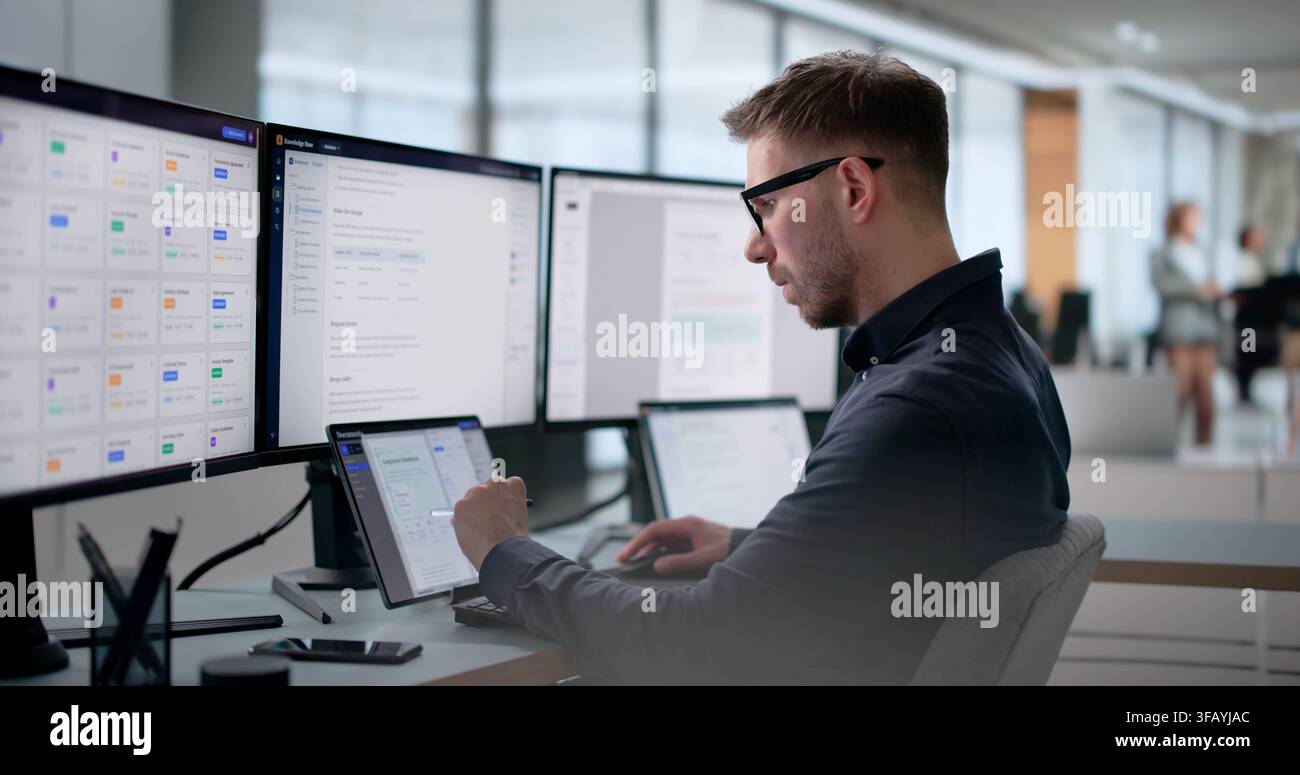 Young Software Engineer Uses Laptop To Build AI-powered Knowledge System. Stock Photo