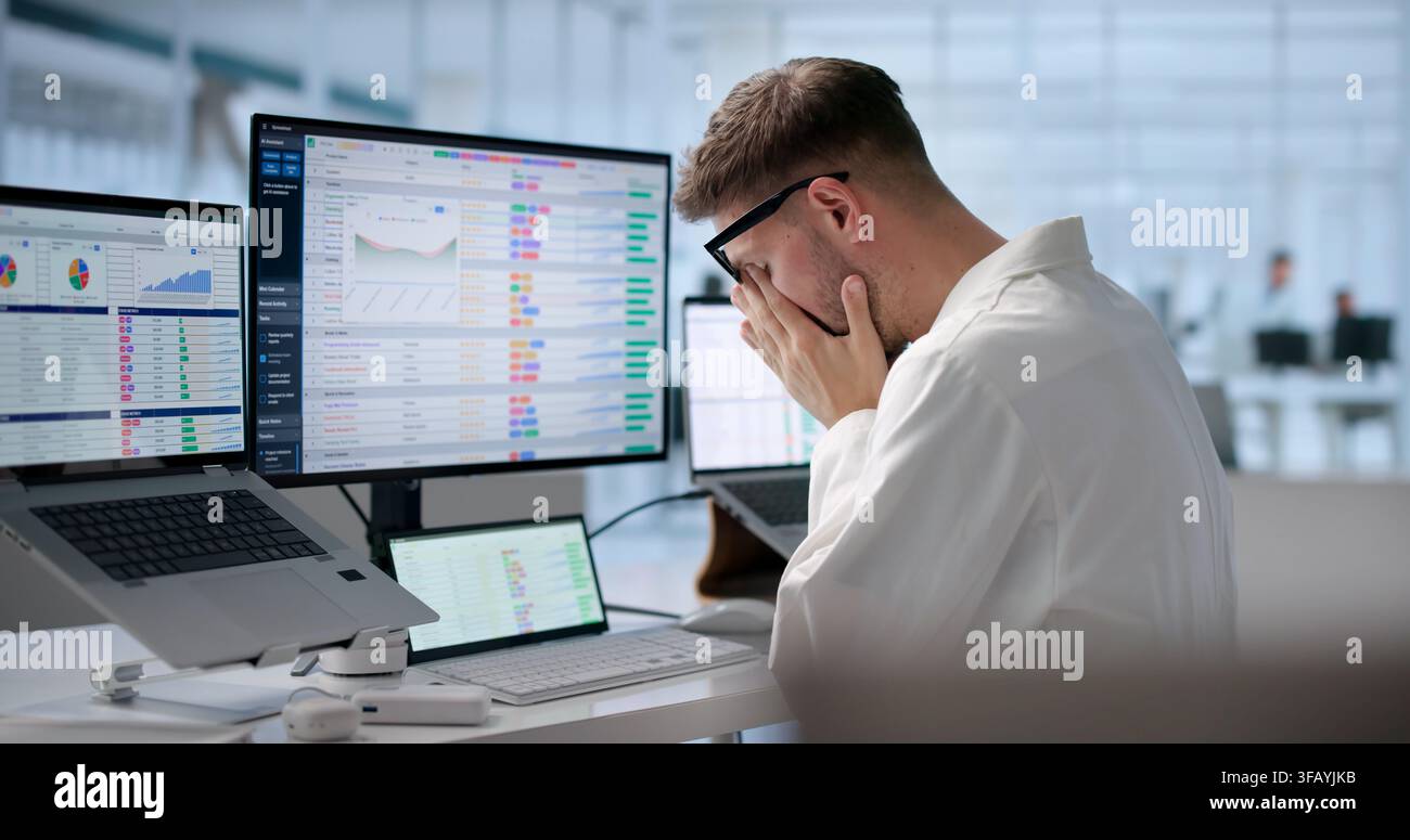 Tired Medical Coder Struggles Managing Hospital Billing Codes Late Night. Stock Photo