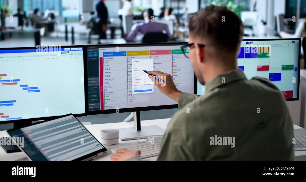 Agile Project Manager Studies Digital Scrum Board Tasks On Laptop Screen. Stock Photo